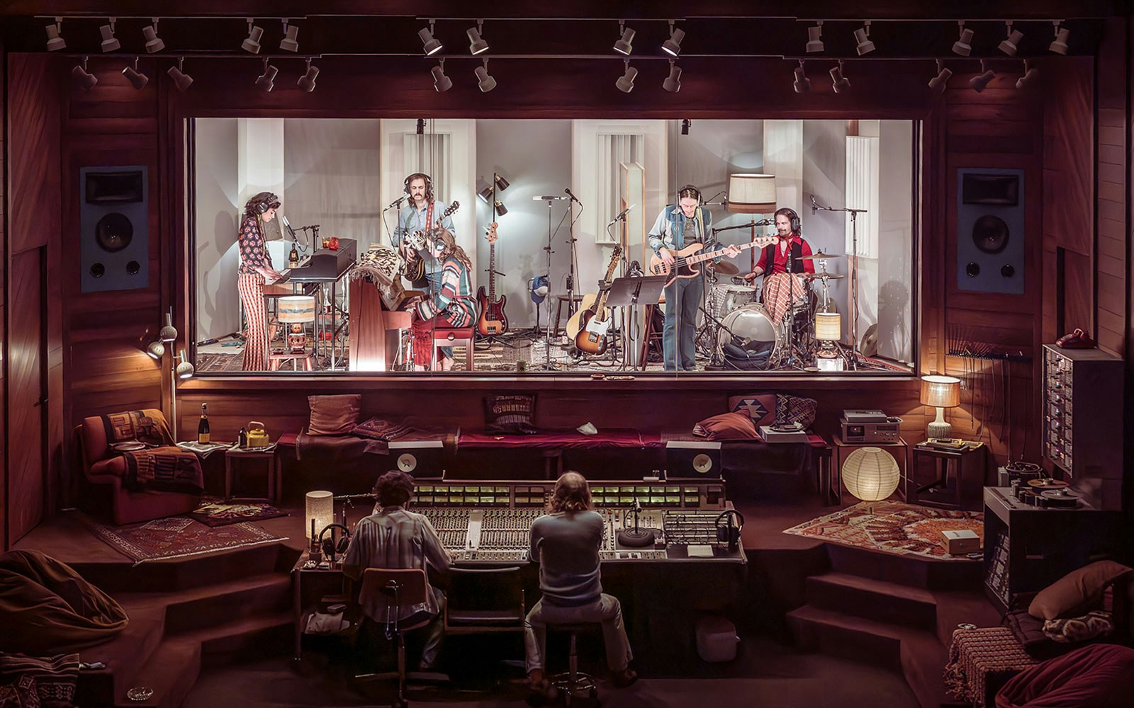 Band recording in a vintage studio with sound engineers, showcasing stereophonic equipment.