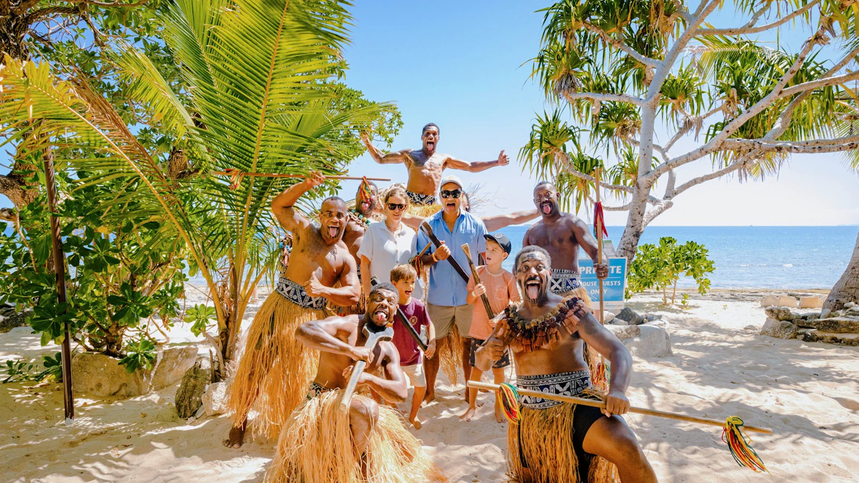 Group enjoying traditional dance on South Sea Island beach, Fiji.