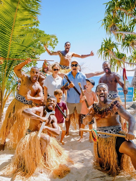 Group enjoying traditional dance on South Sea Island beach, Fiji.