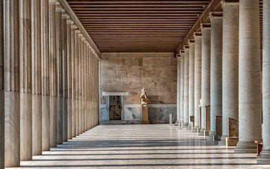 Stoa of Attalos interior with marble columns and statue in Athens, Greece.