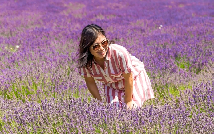 Person enjoying a lavender field during a full day tour.