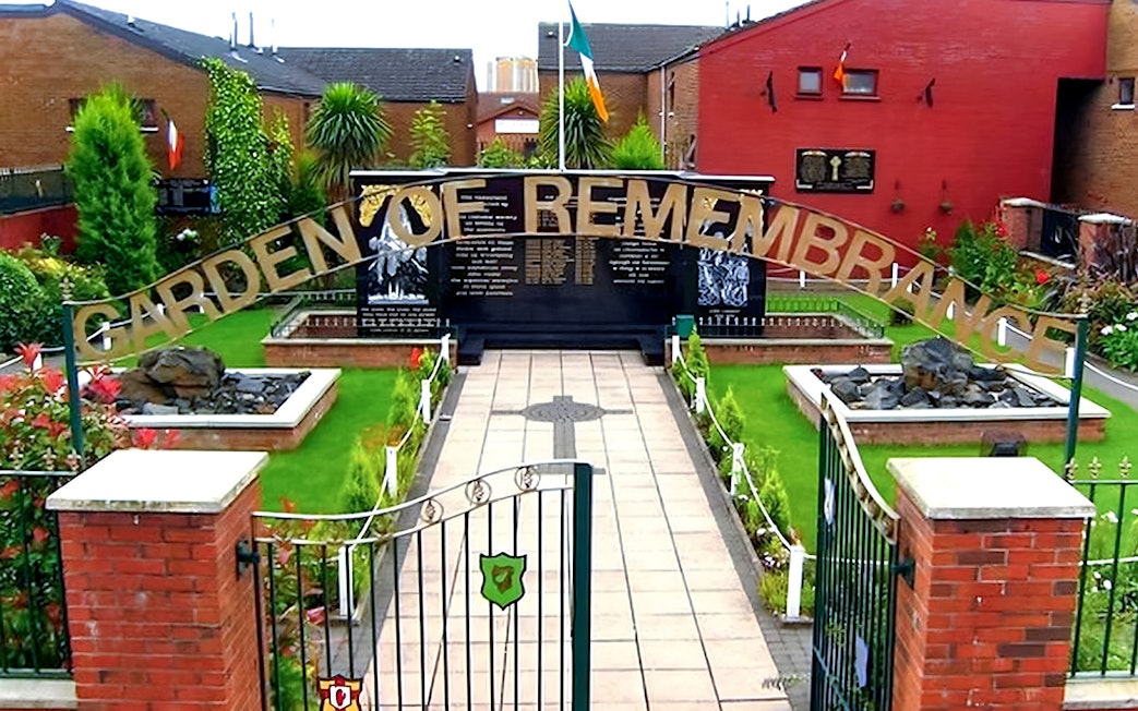 Garden of Remembrance entrance in Belfast, featuring memorial plaques and lush greenery.