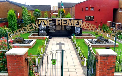 Garden of Remembrance entrance in Belfast, featuring memorial plaques and lush greenery.