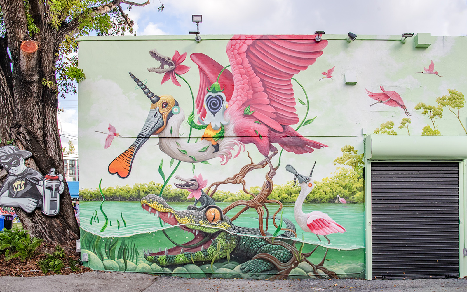 Colorful mural with surreal animals and nature at Wynwood Walls Museum.