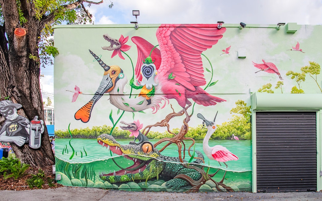 Colorful mural with surreal animals and nature at Wynwood Walls Museum.