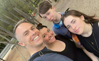 Family enjoying a self-guided city exploration game in a park in Madrid.