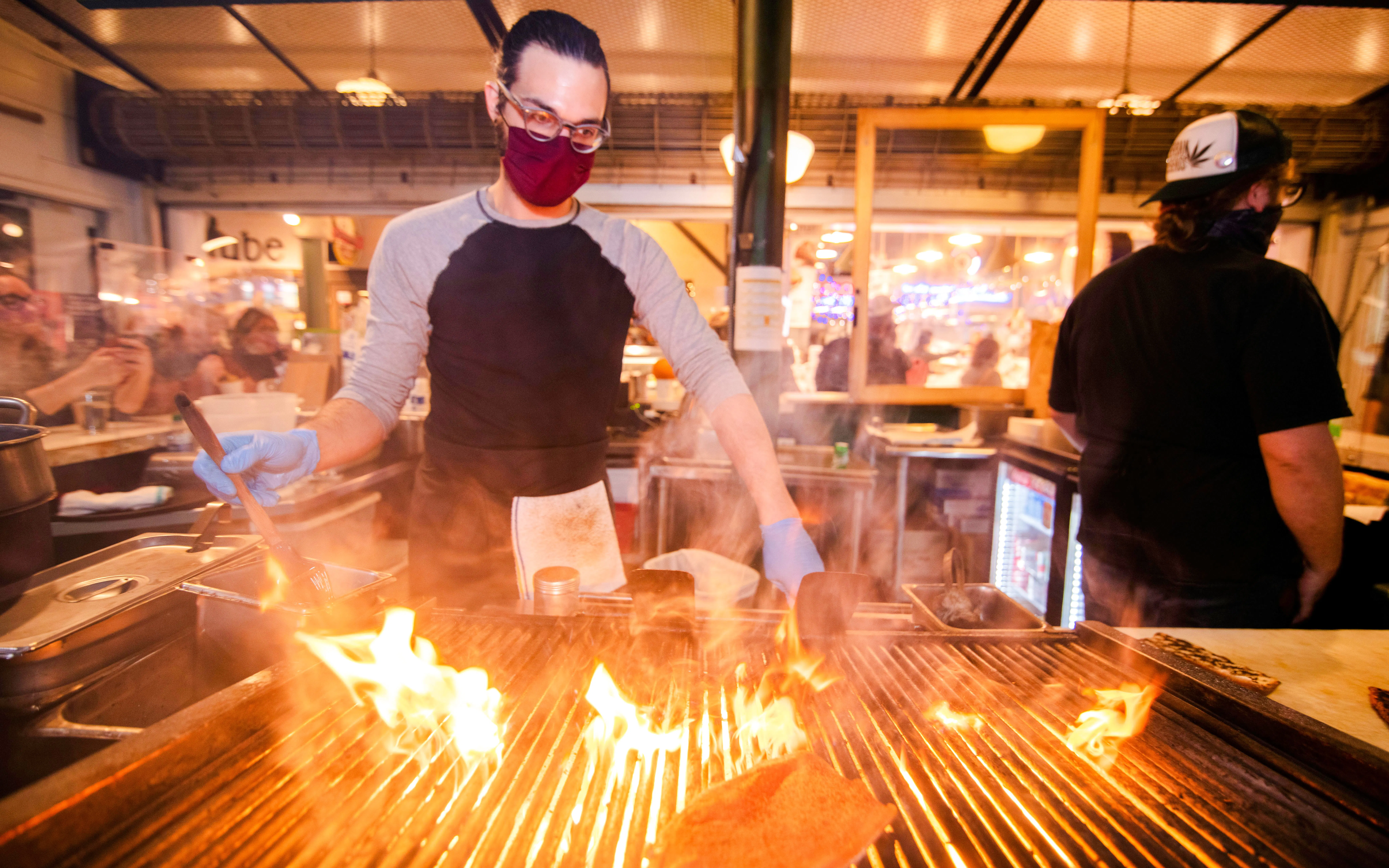 Chef grilling food at Pike Place Market during guided food tour.