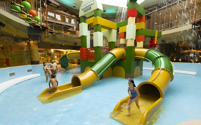 Children playing on water slides at Aquashow Indoor Park.