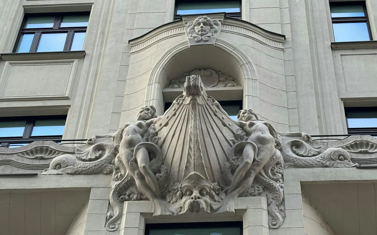 Facade sculpture on a historic building in Budapest, part of the Golden Age Sweet Tastes tour.