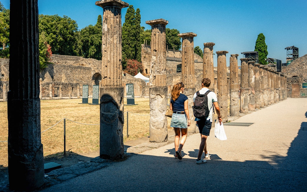 Couple exploring ancient ruins in Pompeii, Italy.