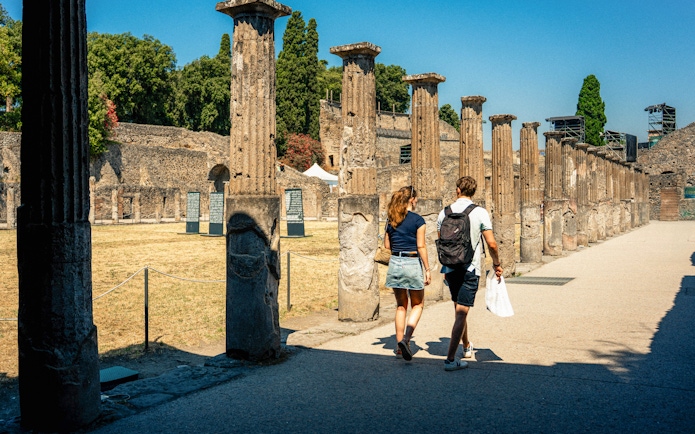 Couple exploring ancient ruins in Pompeii, Italy.