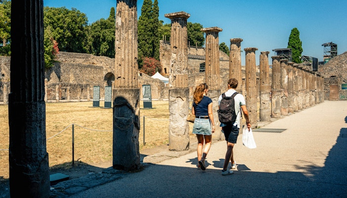 Couple exploring ancient ruins in Pompeii, Italy.