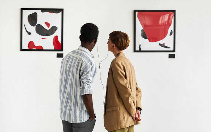 Visitors using audio guide at National Gallery, viewing abstract art.