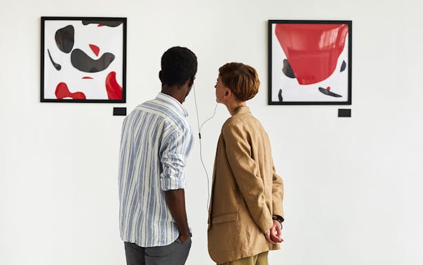 Visitors using audio guide at National Gallery, viewing abstract art.