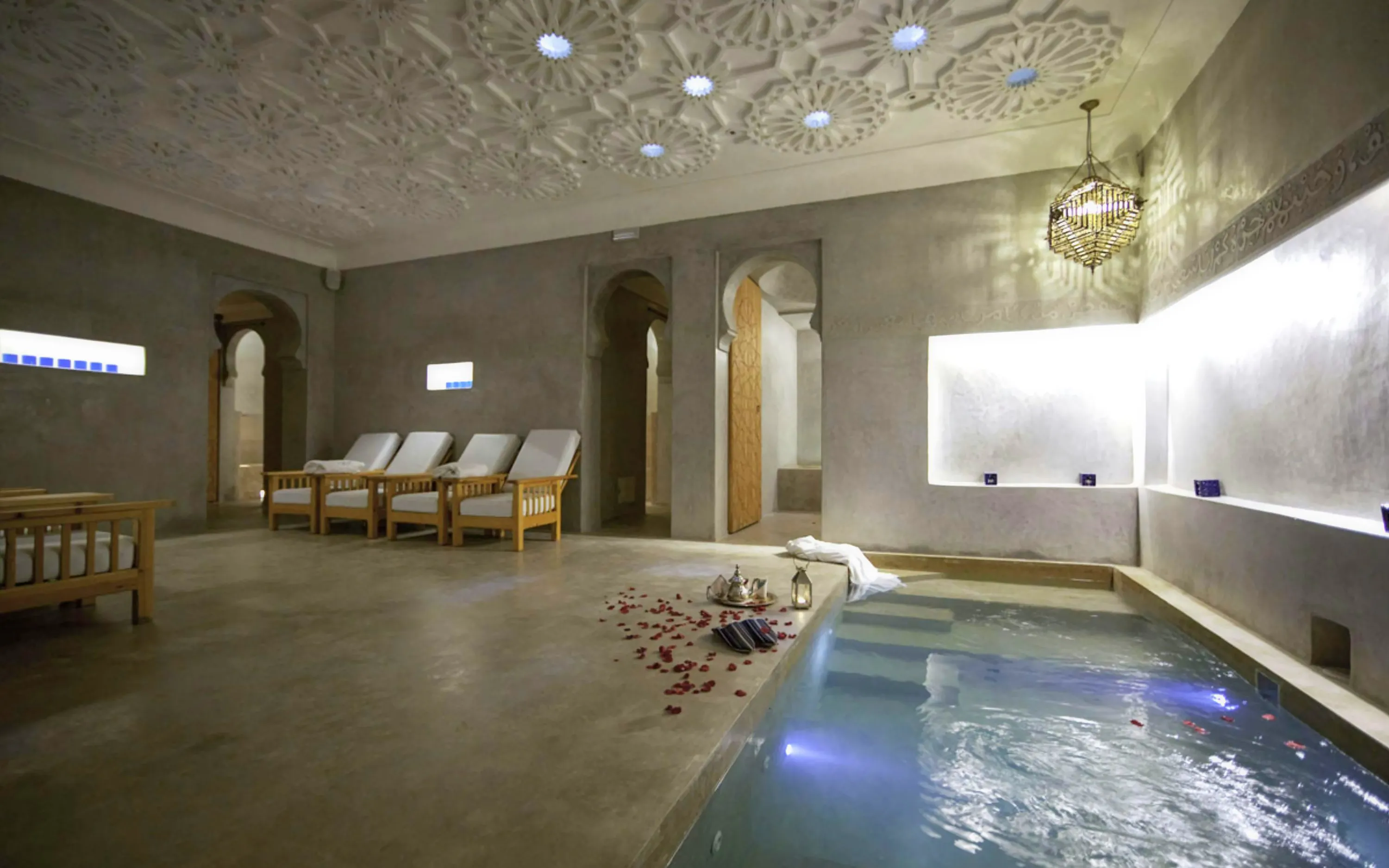 Le Bain Bleu Hammam & Spa pool area with lounge chairs, Marrakesh.