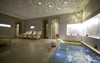 Le Bain Bleu Hammam & Spa pool area with lounge chairs, Marrakesh.
