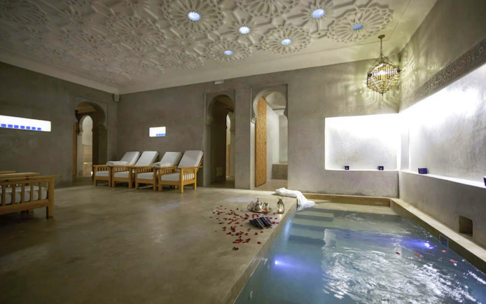 Le Bain Bleu Hammam & Spa pool area with lounge chairs, Marrakesh.