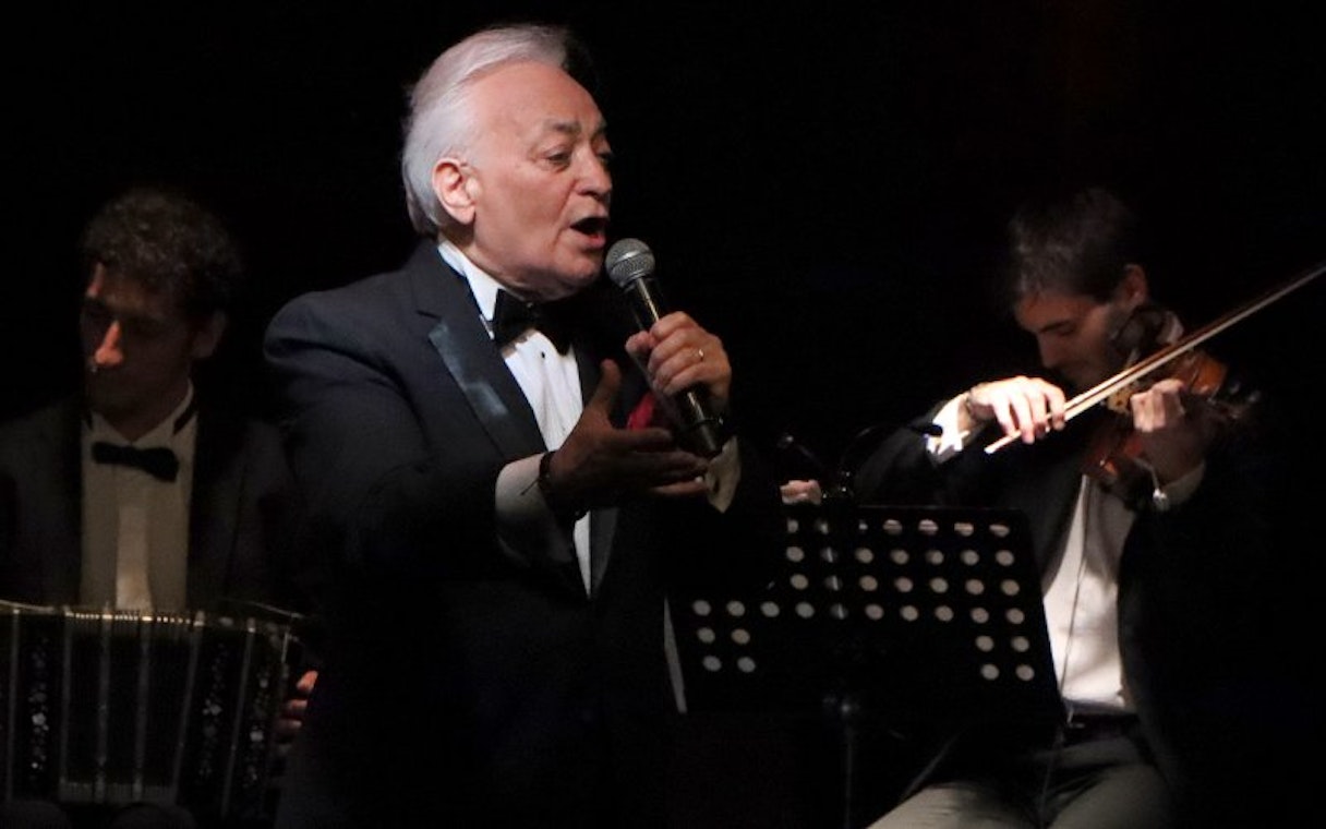 Singer performing with musicians at Michelangelo Tango Show.