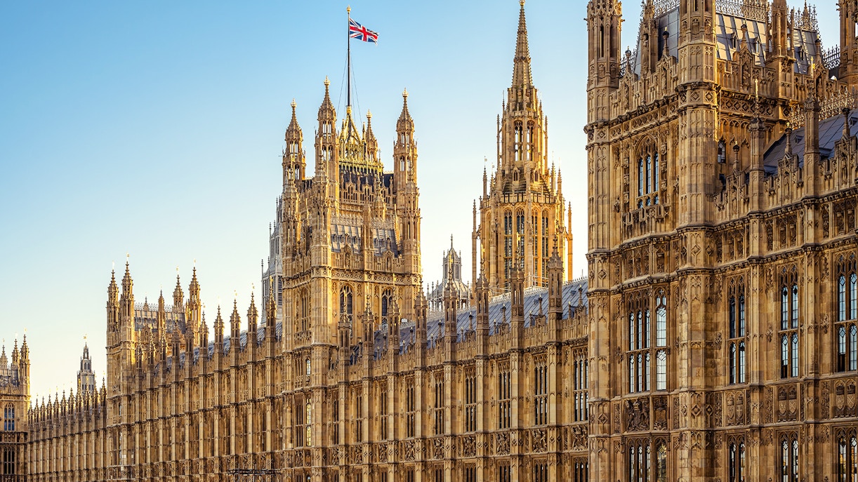Facade of the Palace of Westminster with Union Jack flag, London.