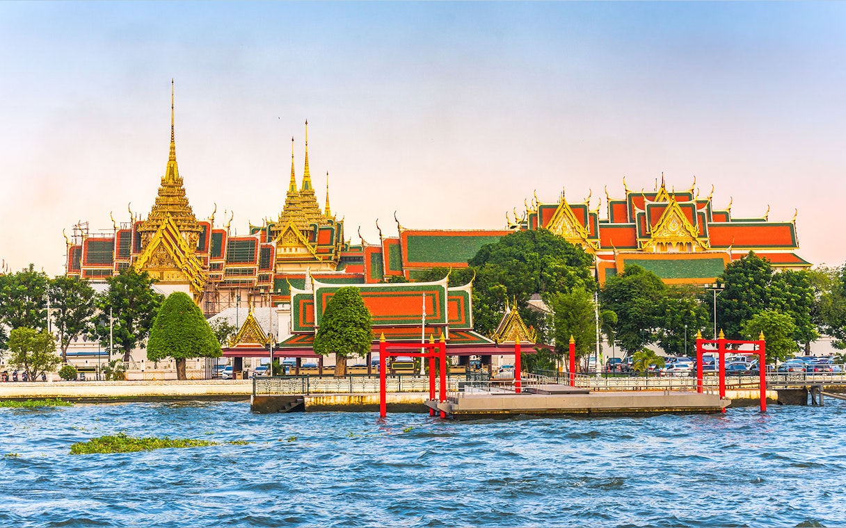 Grand Palace view from Chao Phraya River, Bangkok, with hop-on-hop-off boat dock.