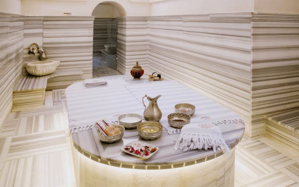 Catmamescit Hamam in Beyoglu with traditional marble interior and bathing accessories.