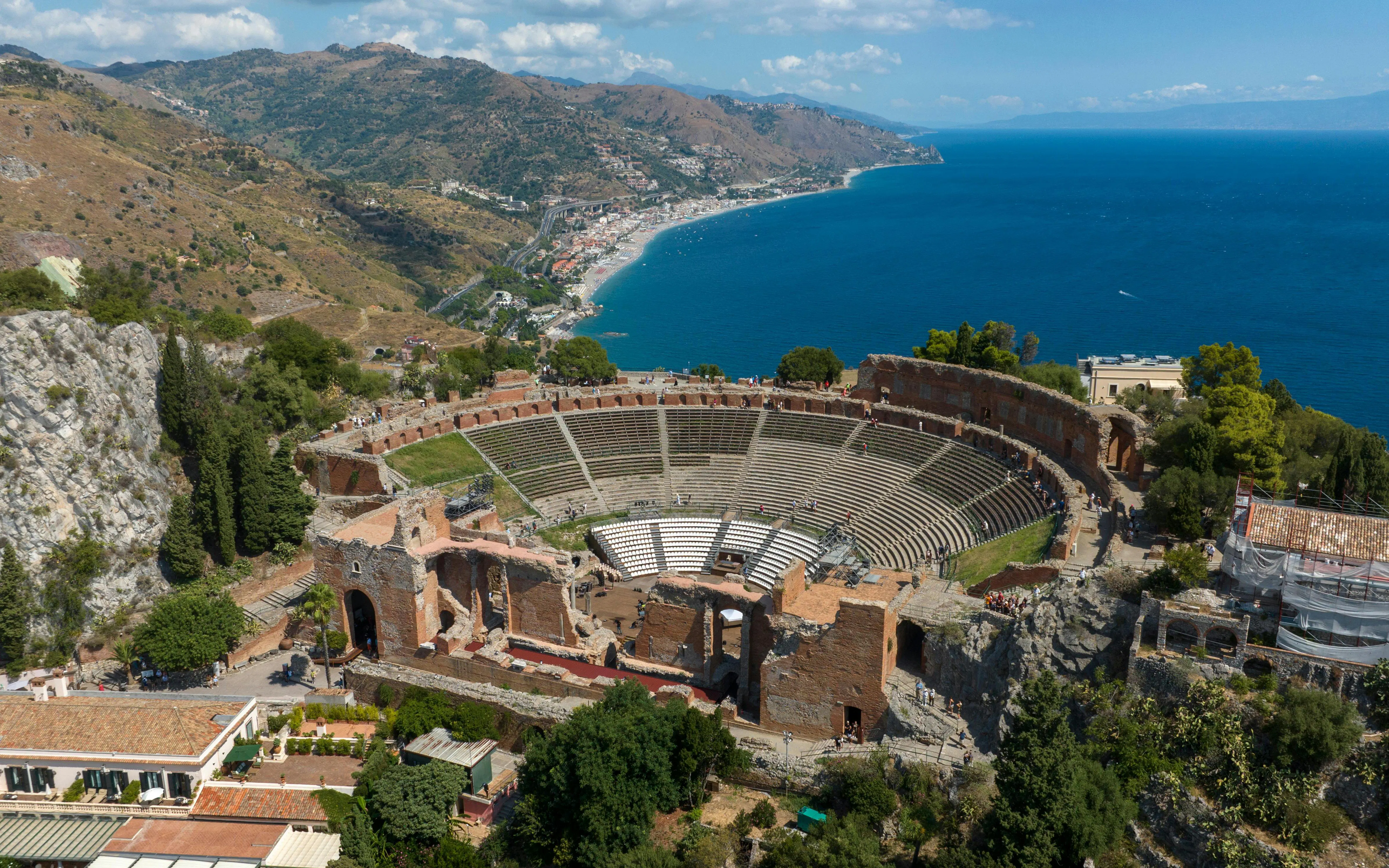 Ancient Greek theatre overlooking the coast in Taormina, Sicily, Italy.