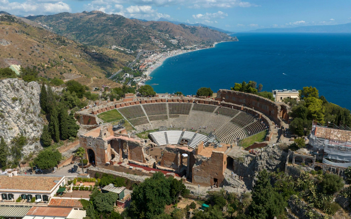 Ancient Greek theatre overlooking the coast in Taormina, Sicily, Italy.