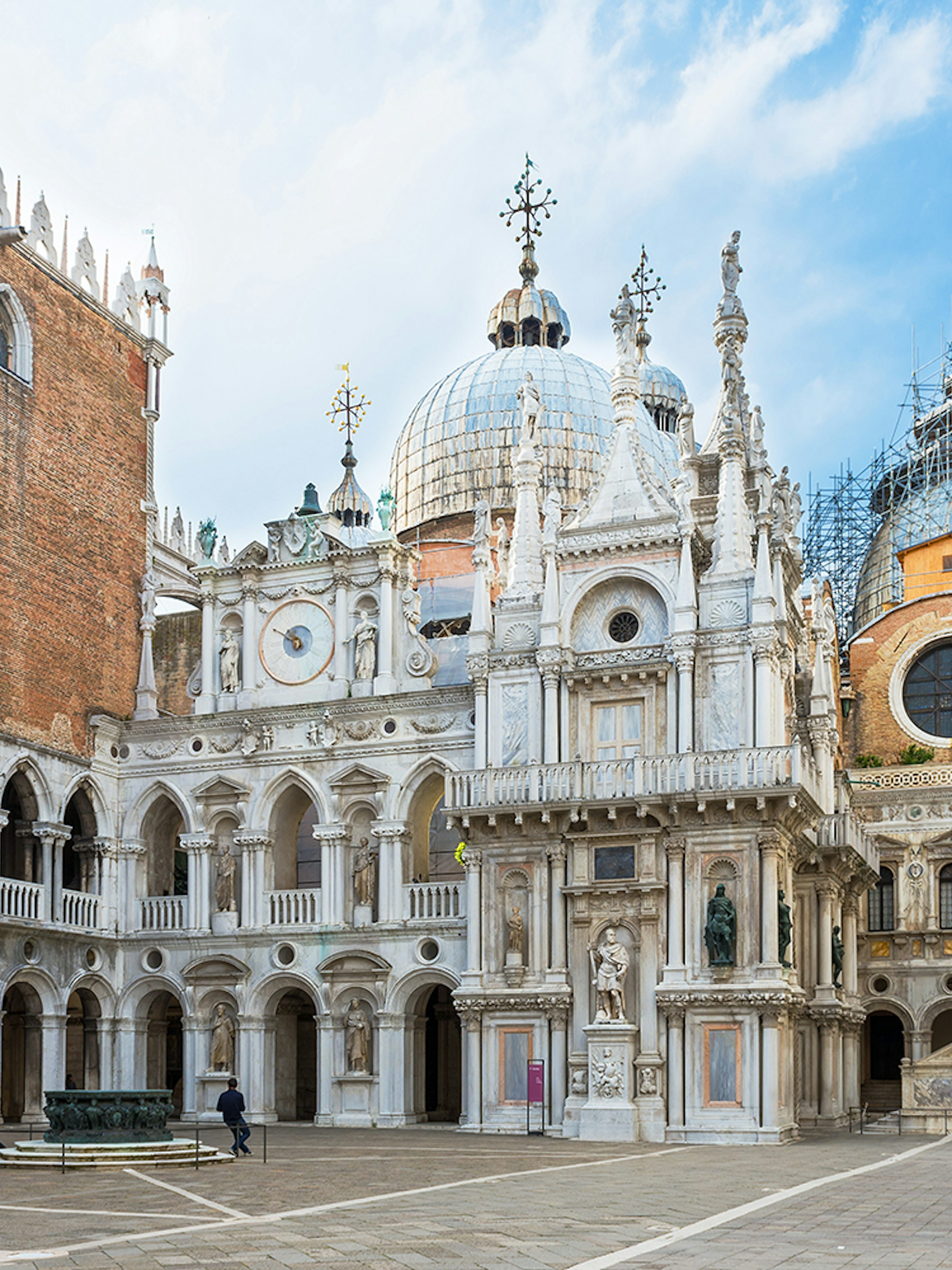 Courtyard of Doge's Palace with ornate architecture and statues, Venice, Italy.