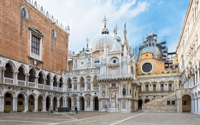 Courtyard of Doge's Palace with ornate architecture and statues, Venice, Italy.