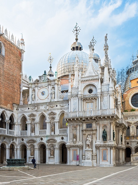 Courtyard of Doge's Palace with ornate architecture and statues, Venice, Italy.