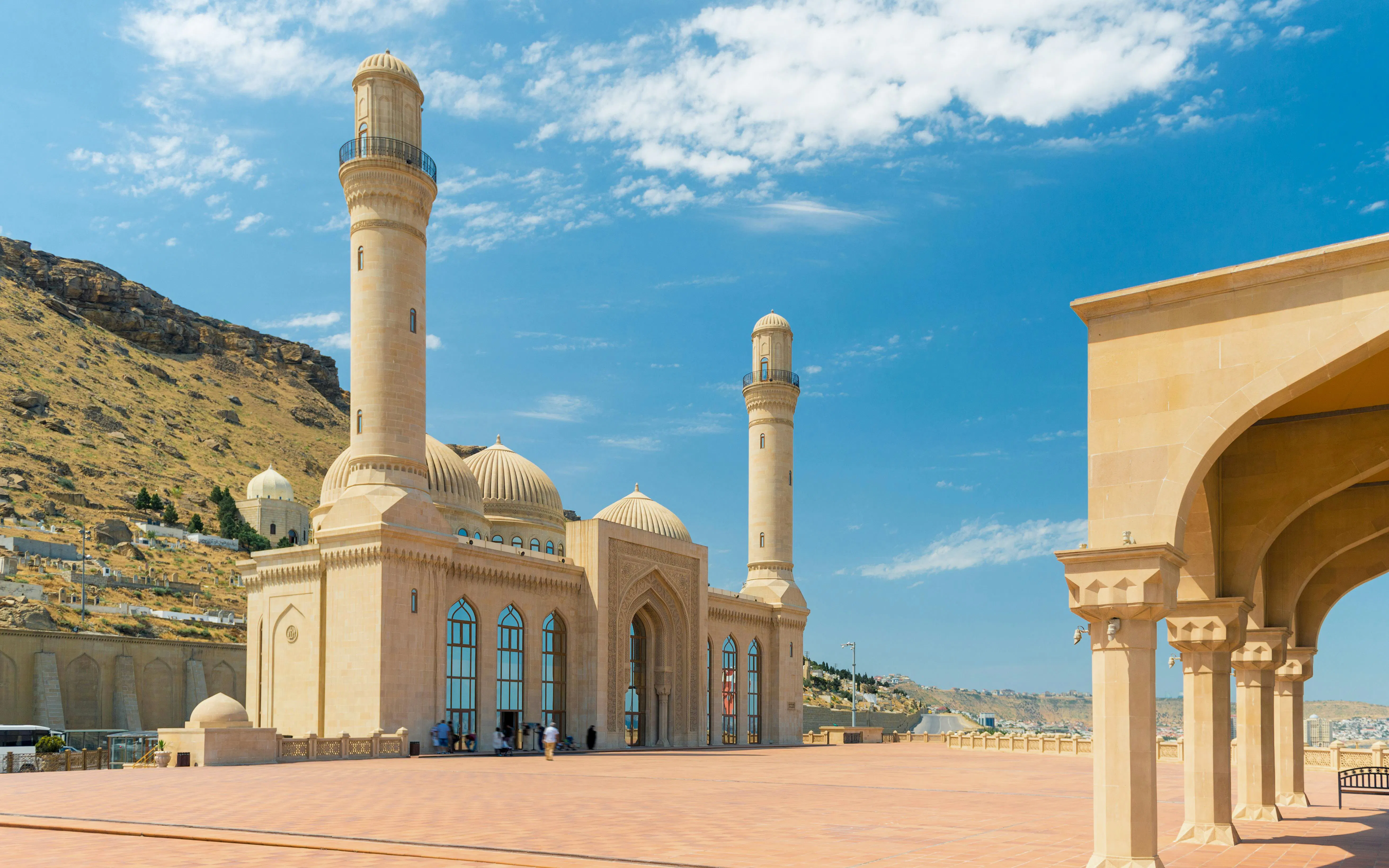 Bibi Heybat Mosque with minarets and domes in Baku, Azerbaijan under a clear blue sky.