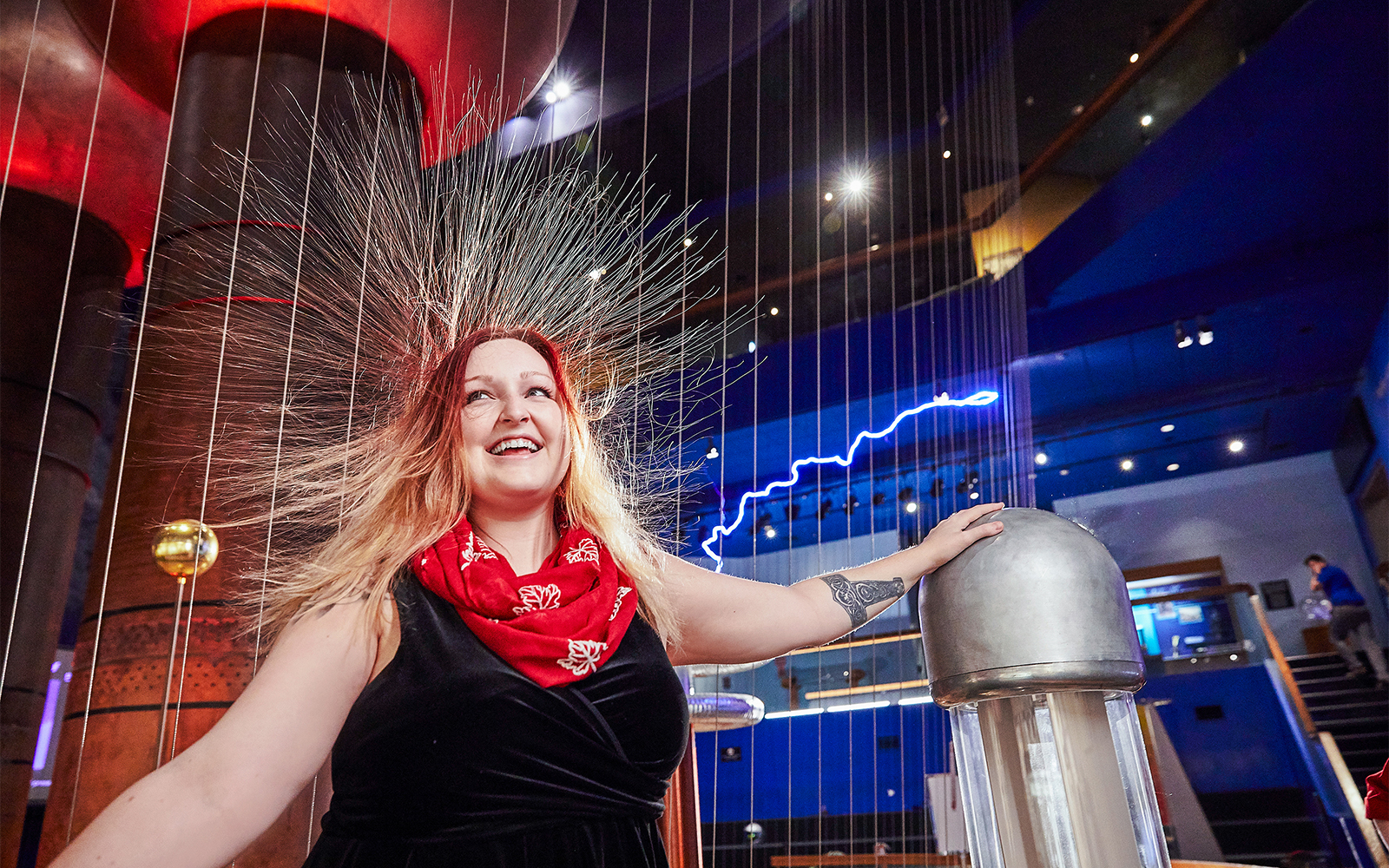 Visitor experiencing static electricity at Museum of Science Theater of Electricity.