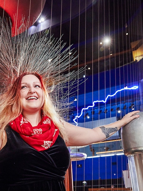 Visitor experiencing static electricity at Museum of Science Theater of Electricity.