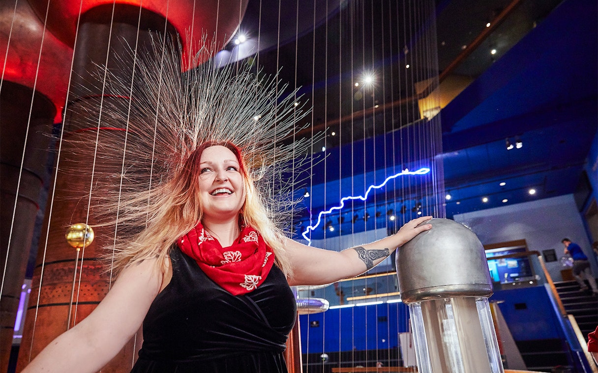 Woman experiencing static electricity at Museum of Science Theater of Electricity, Boston.