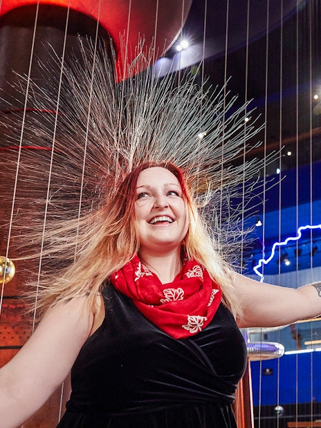 Woman experiencing static electricity at Museum of Science Theater of Electricity, Boston.