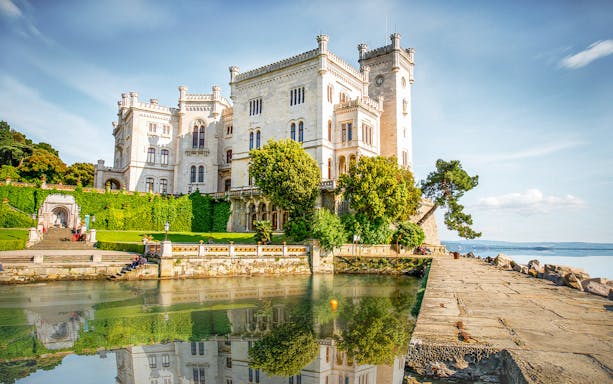 Miramare Castle with lush gardens and sea view, Trieste, Italy.