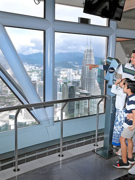 Family enjoying city view from KL Tower Sky Deck, Kuala Lumpur.