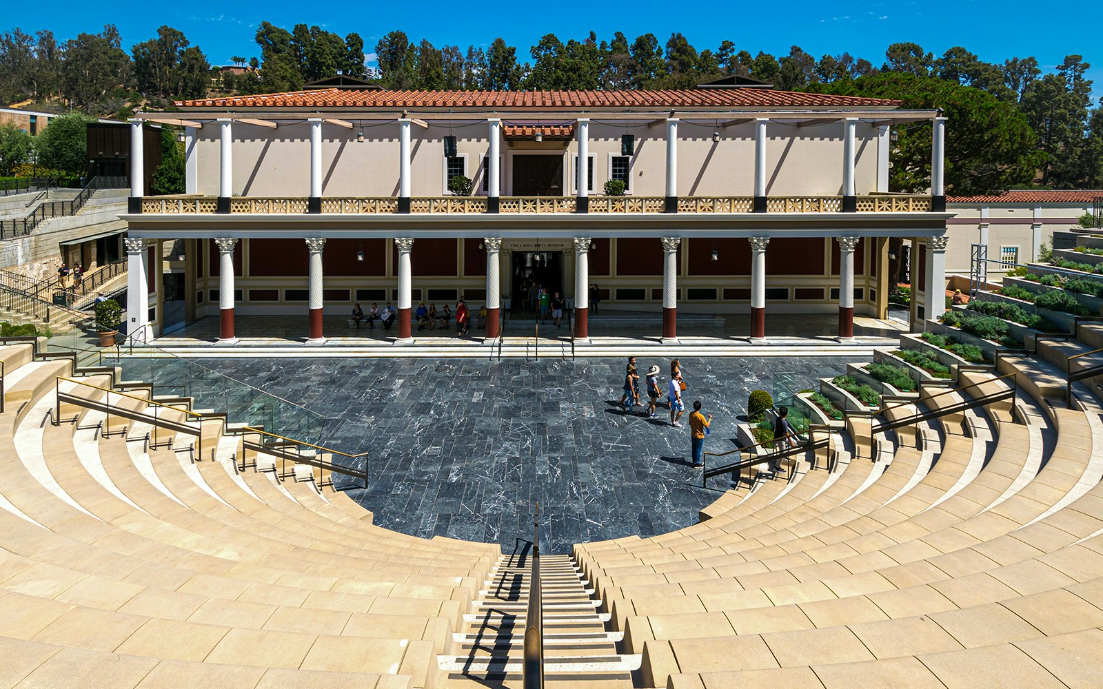 Amphitheater at Villa of the Papyri with visitors exploring the site.