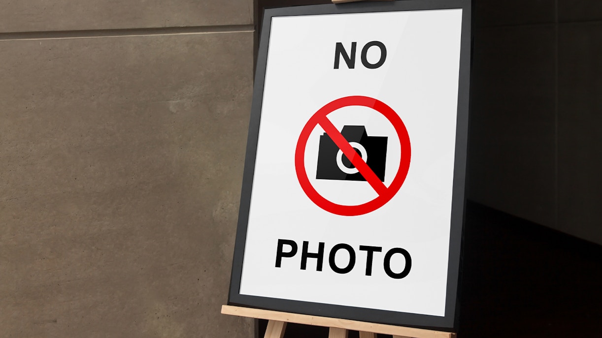 Photography not allowed sign at a tourist attraction entrance.