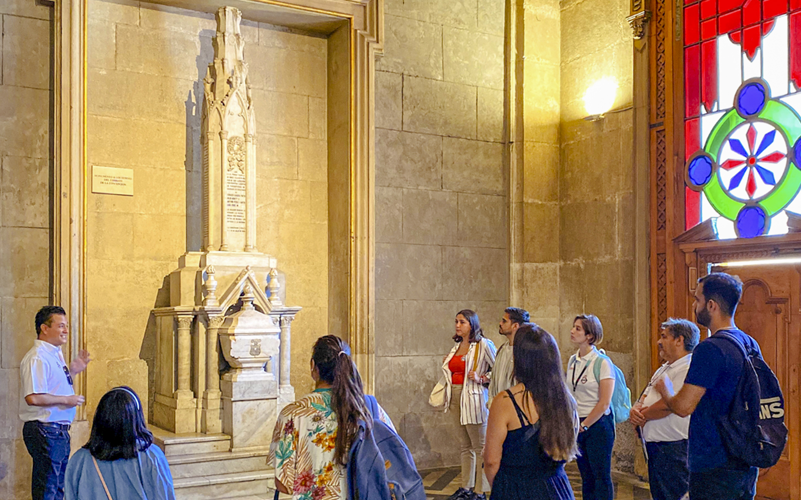 Guests with guide inside Santiago Cathedral, viewing a historic monument.