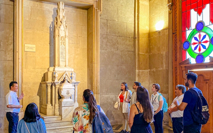 Guests with guide inside Santiago Cathedral, viewing a historic monument.