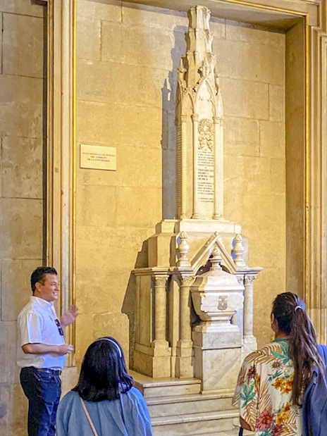 Guests with guide inside Santiago Cathedral, viewing a historic monument.