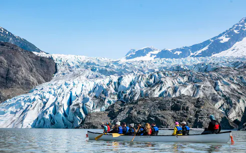 Canoe group paddling near Mendenhall Glacier in Alaska.