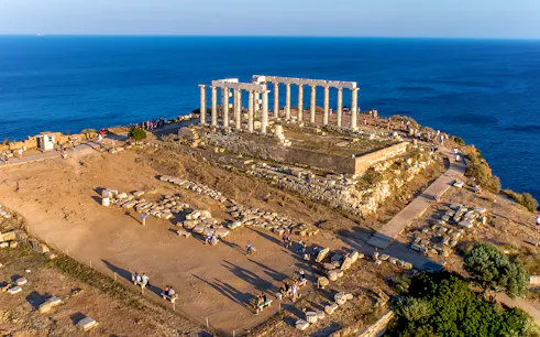 Aerial view of the Temple of Poseidon at Cape Sounio, Attica, Greece with surrounding sea.