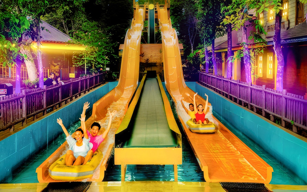 People enjoying water slides at Sunway Lagoon Night Park, Kuala Lumpur.
