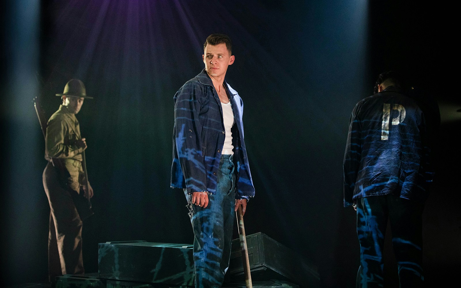 Actors performing a scene from "From Here To Eternity – The Musical" on stage.