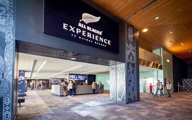 Entrance to the All Blacks Experience in New Zealand with visitors inside.