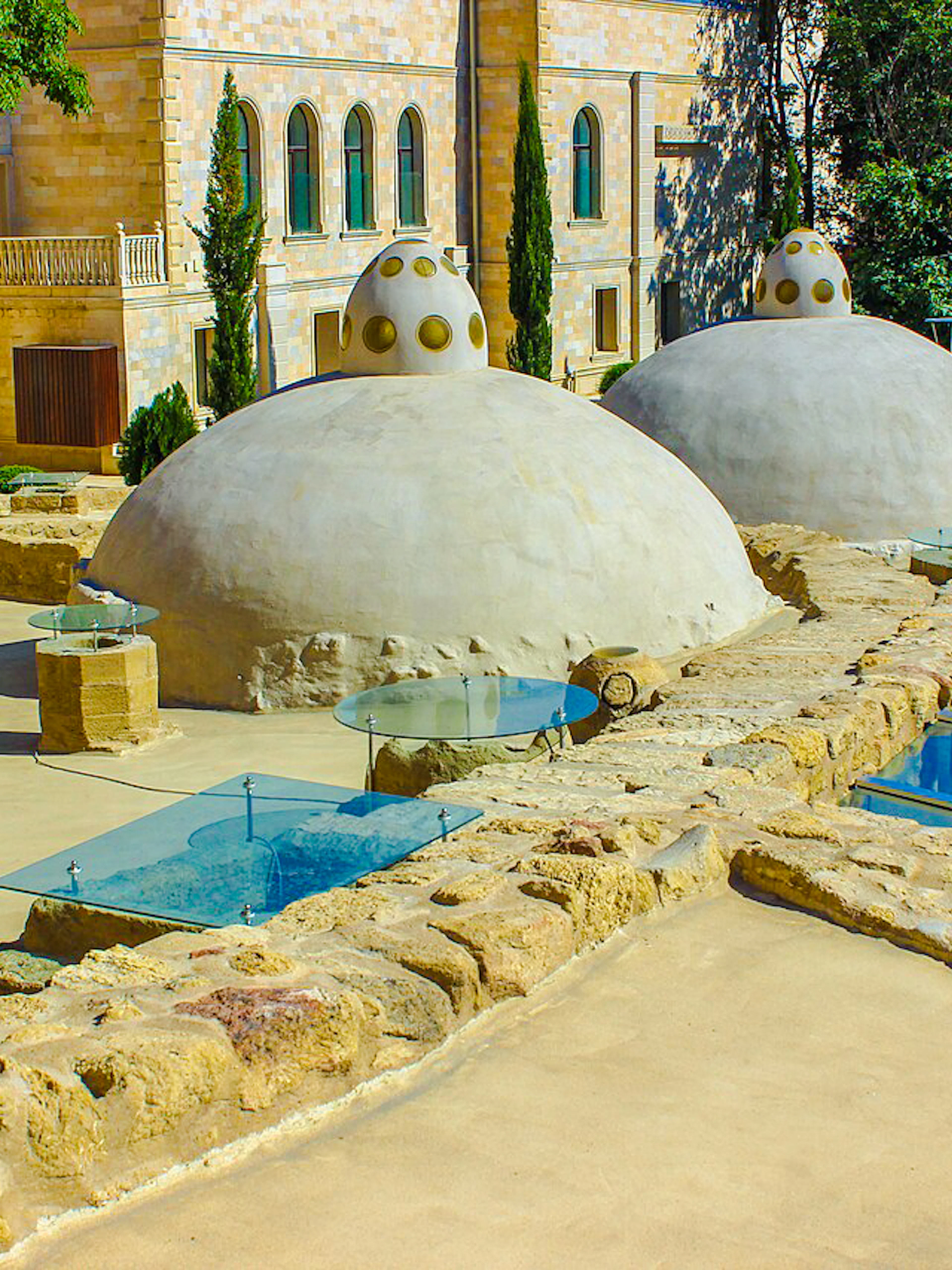 Underground hammam domes and glass skylights in Baku complex.