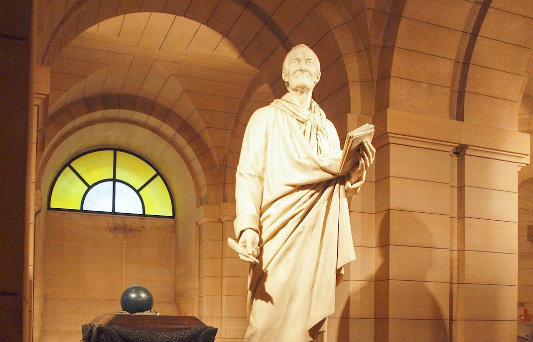 Voltaire's tomb inside the Paris Pantheon, showcasing intricate architectural details.