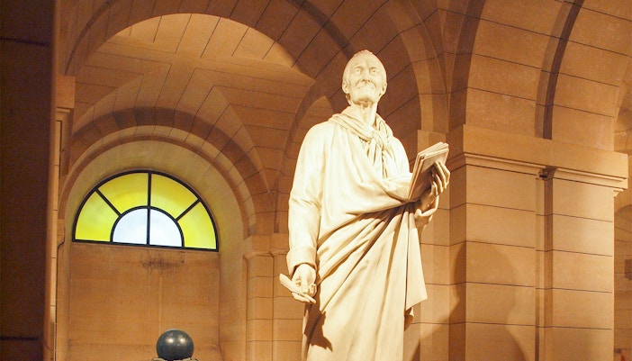 Voltaire's tomb inside the Paris Pantheon, showcasing intricate architectural details.